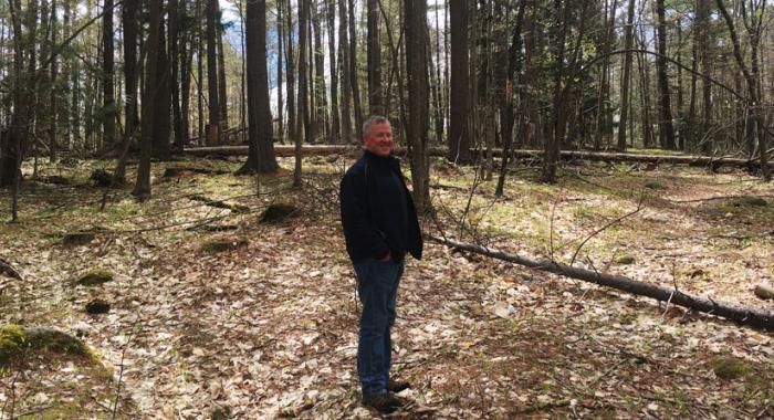 Mike Morison standing in his woods