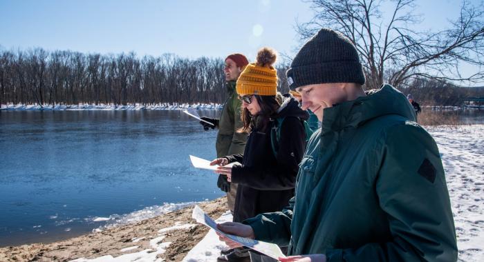 UNH grad students in parkas survey from bank of Merrimack River