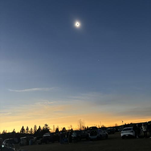 The sky looks like sunset as the eclipse in totality is seen overhead.