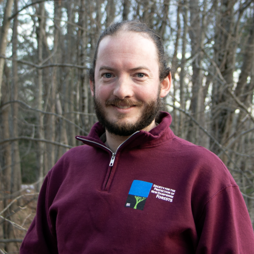 Dylan Summers poses outside on the Conservation Center deck in winter.