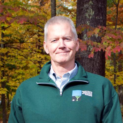 Tony Cheek poses outside the Conservation Center for a photo in autumn.