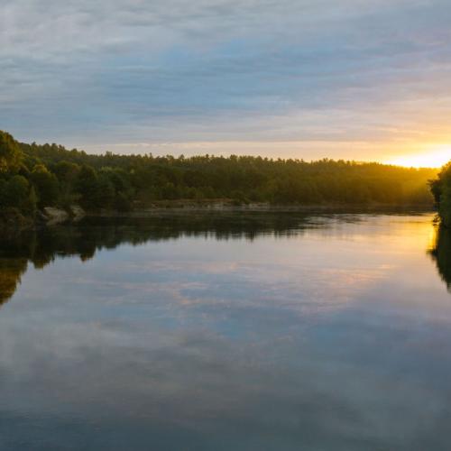 The sun sets over the Merrimack River near the Forest Society's conservation area.