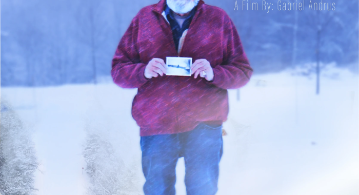 Movie poster of older man in a red hat holding a photograph in front of text "Remember Winter"