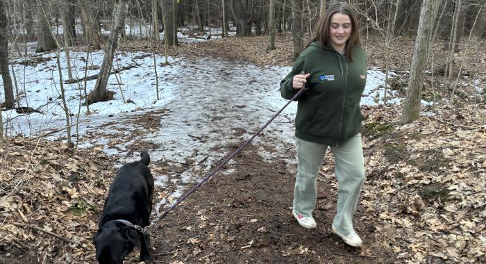 Sophie Oehler takes her dog, Auggie, for a walk on the partially frozen floodplain.