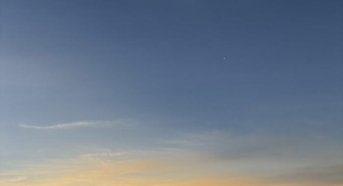 The sky looks like sunset as the eclipse in totality is seen overhead.