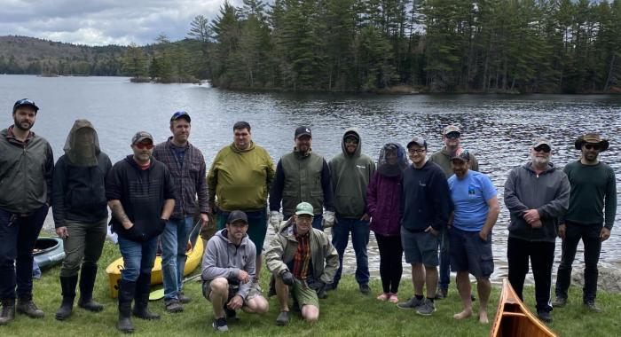 Hypertherm employees pose by Grafton Pond.