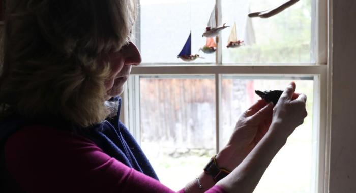 Sy Montgomery holds a hatchling up to the window.