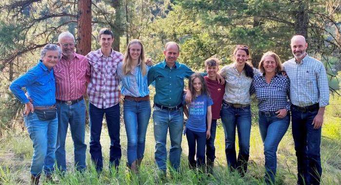 The Wells family poses together on their land.
