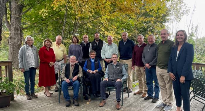 The board poses on the Conservation Center deck in a large group.
