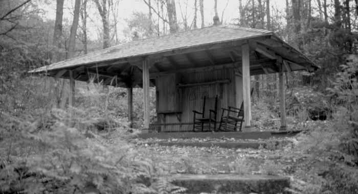 The gazebo, or bee house, in summer in black and white.
