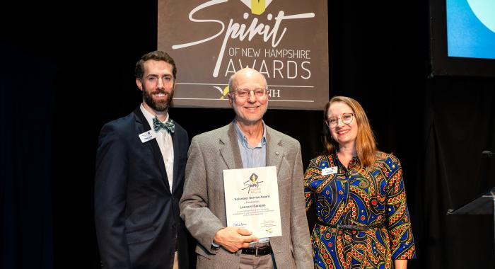 Lee poses with a plaque at the Spirit of NH Awards.