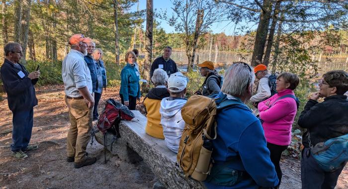 Group hike at a wetland overview at Monson Center