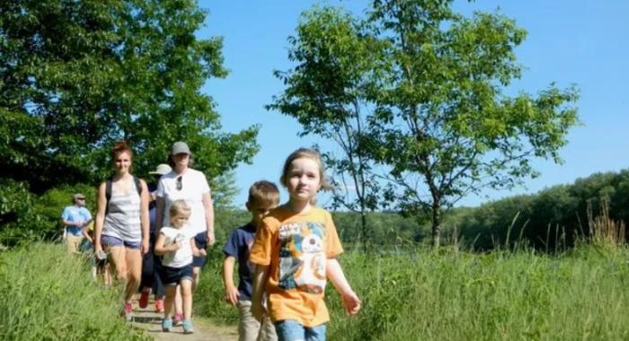 Family walks along the floodplain trail
