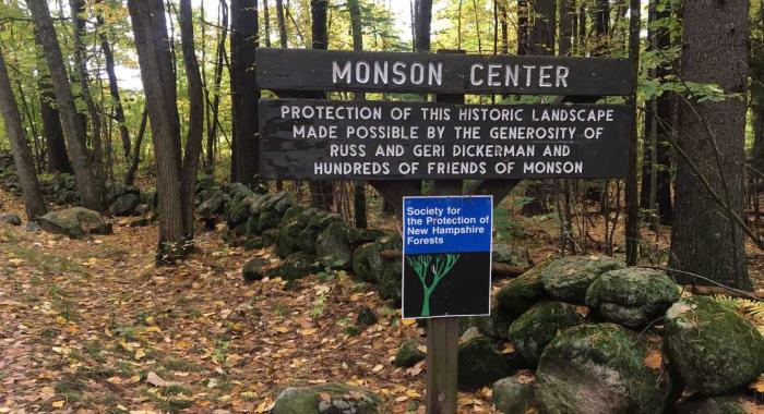 A wood sign at the entrance to Monson Center.