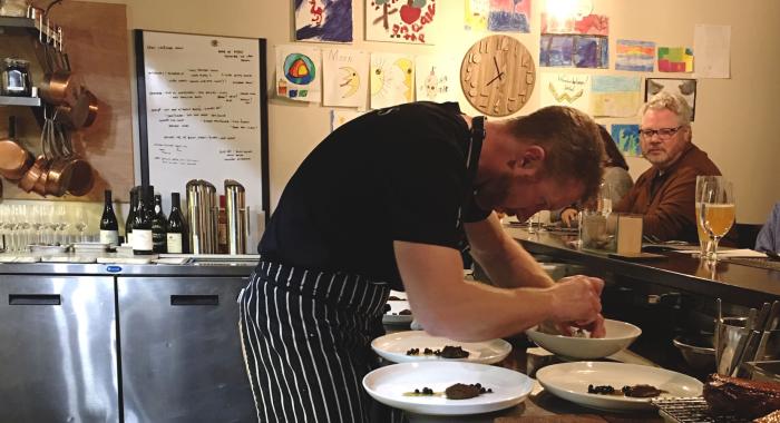 Chef Evan Hennessey plates at the Chef's Counter at his restaurant, Stages at One Washington Street in Dover.