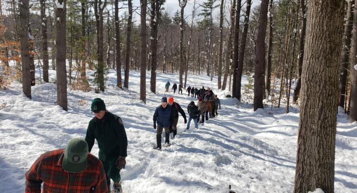 Participants at the SAF regional conference walk at Heald Tract on a snowy path in Wilton.