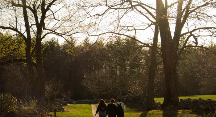 Three young people walk together at Monson Center reservation.