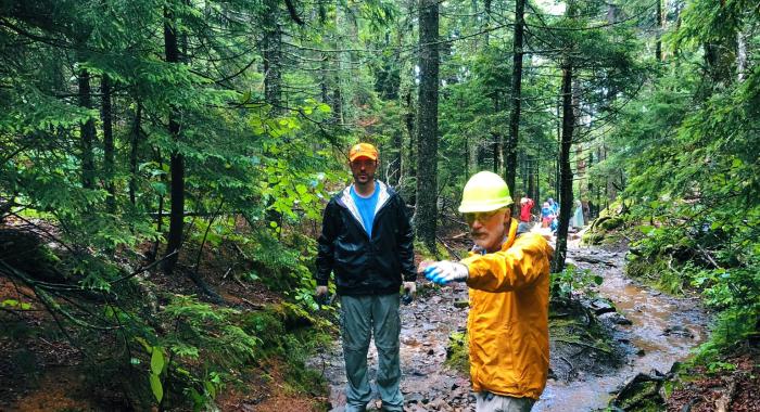 Forest Society Forester Steve Junkin and Volunteer Dave Heuss strategize where to move rocks in order to divert water around a section of the White Arrow Trail at Mount Monadnock. 