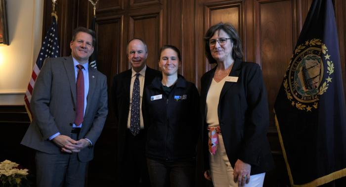 Forest Society staff Leah Hart poses with Governor Sununu and LCHIP leaders.