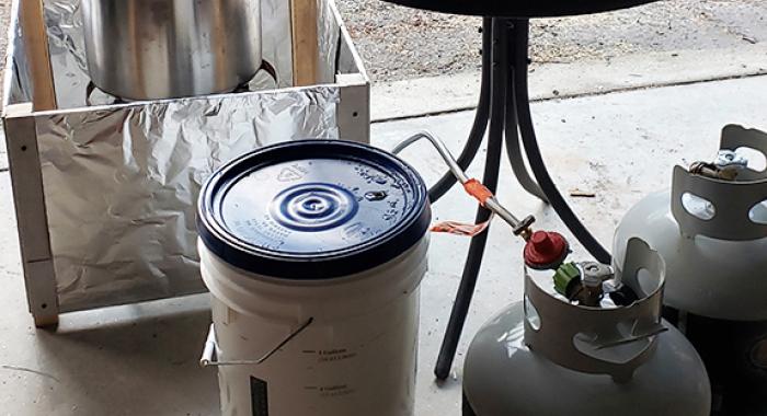 Steve Junkin's evaporation set-up in his garage includes plastic buckets, propane tanks and more.
