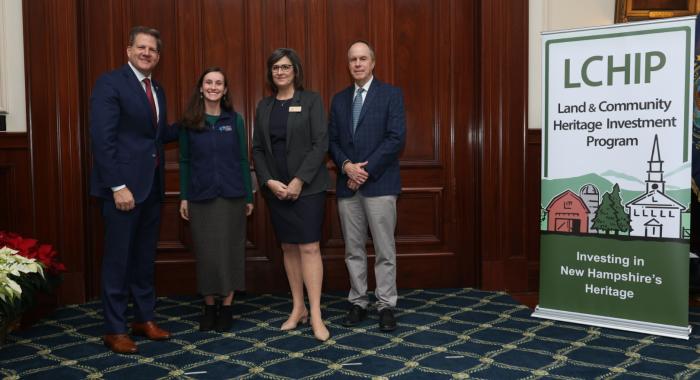 Gov. Sununu poses with Stacie Hernandez and LCHIP leaders at the Statehouse.