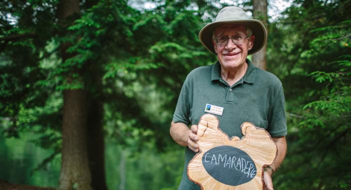 "Camaraderie" sums up this land steward's volunteer experience. Written on a rustic tree cookie chaulkboard.