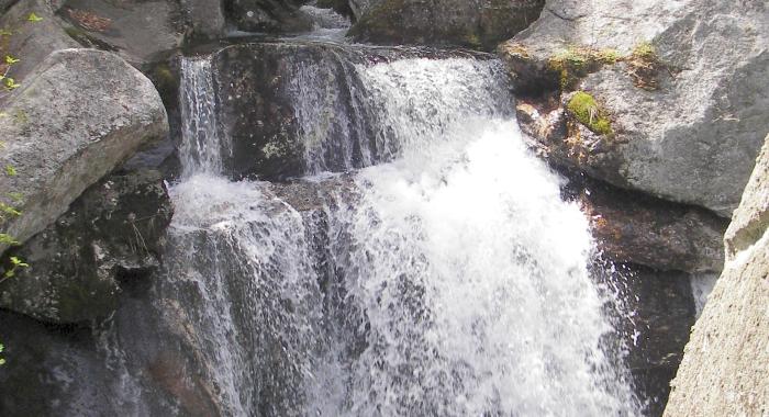 Water falls through granite rocks.