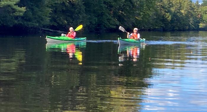 Kayakers paddle on the Contoocook River.