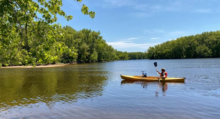 Father and son paddling a kayak on the Merrimack.