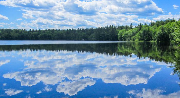 A reflection of blue skies and clear water at Lake Massabesic.