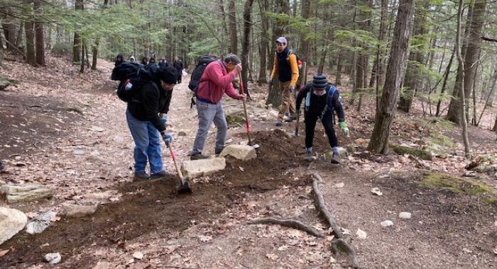 Volunteers dig on the Main Trail at Mount Major as Andy Crowley supervises.