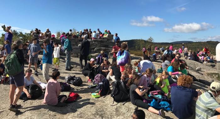 Mount Major summit covered with people during a school hike