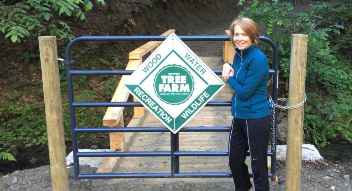 Colleen stands near a bridge on her property.