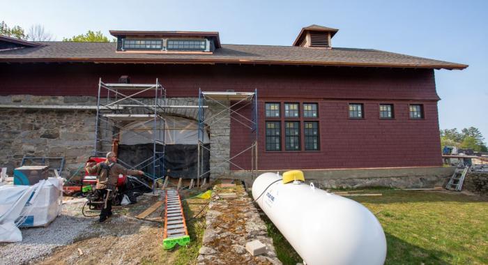 A view of the iconic exterior of the Carriage Barn doors under construction into a beautiful window.