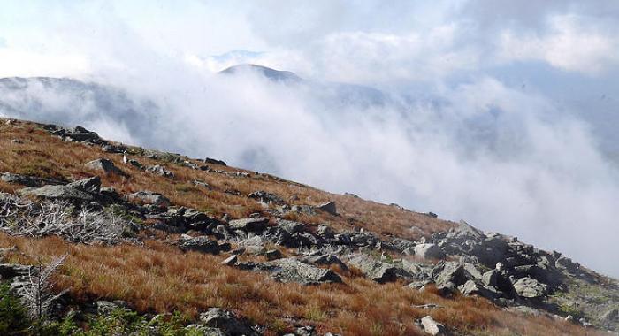 A southwesterly view of Mount Washington with clouds above.