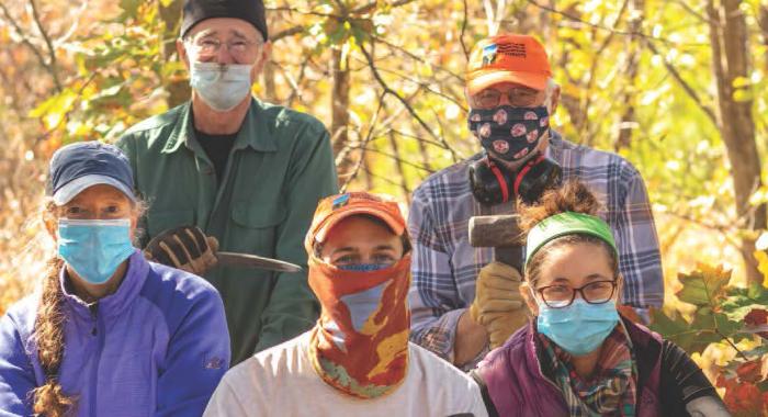 Masked members of the Forest Society's conservation corps gather.