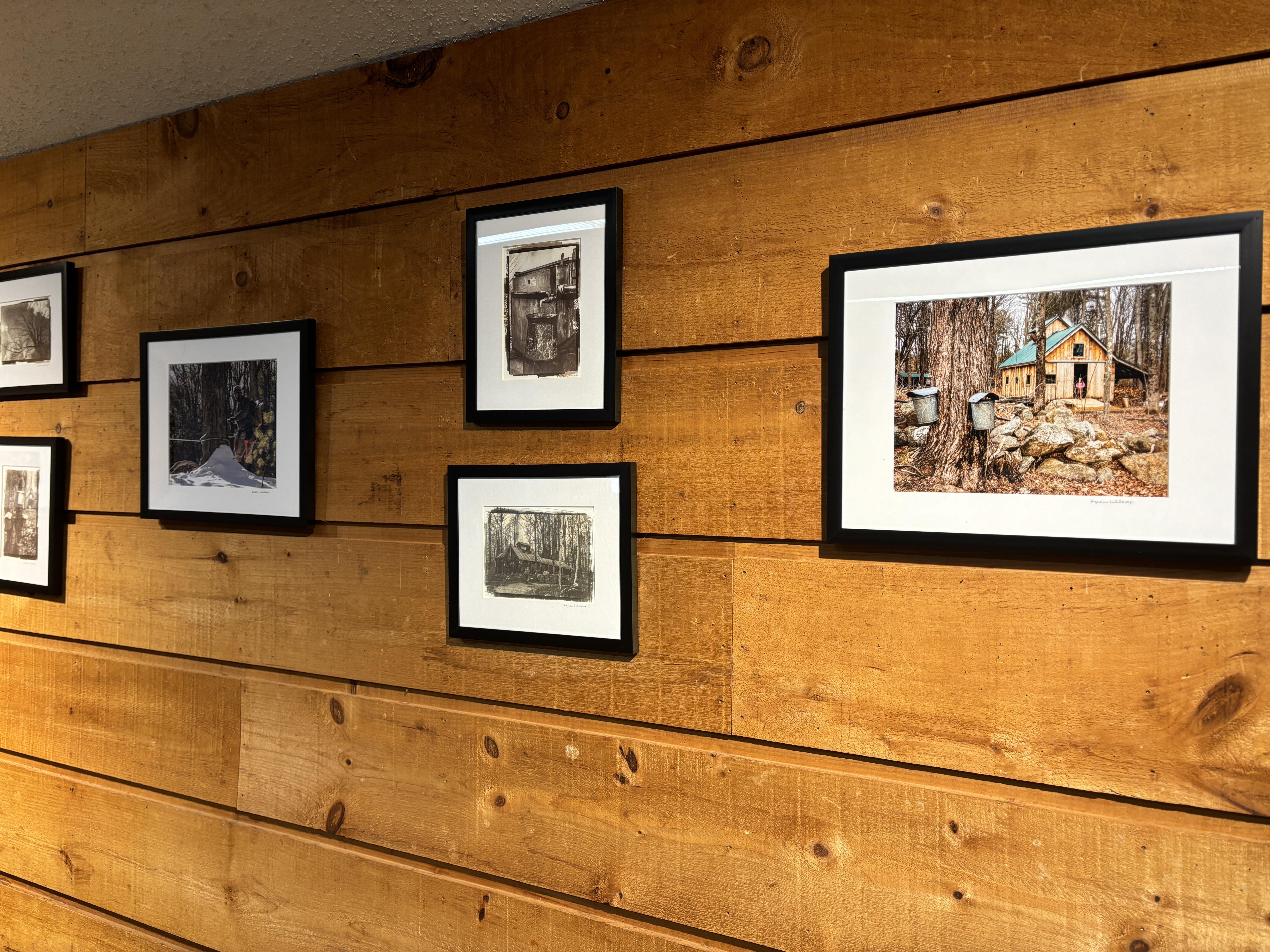 Photographs of sugar houses hang on the wall of the Conservation Center.