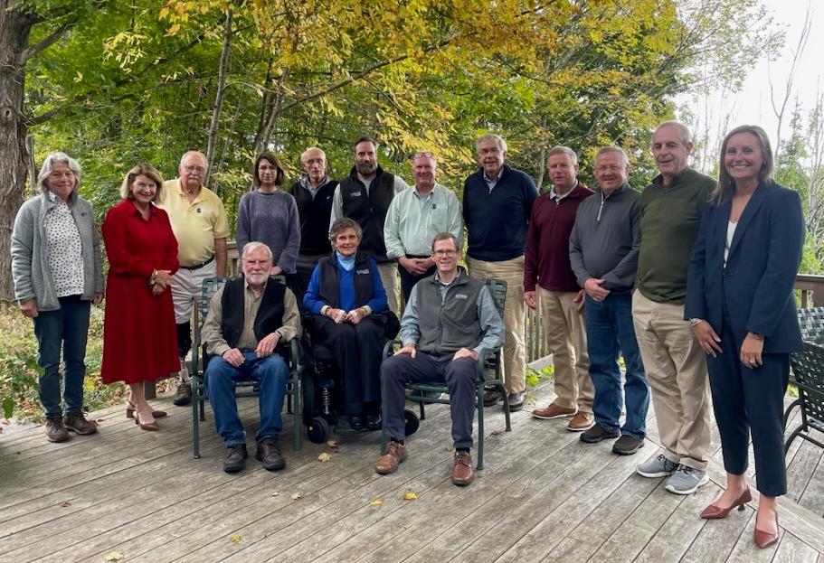 The board poses on the Conservation Center deck in a large group.
