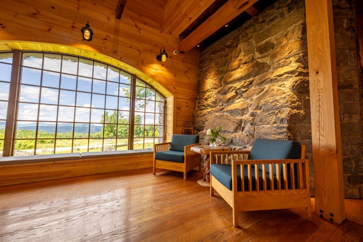 Two chairs near a large picture window in the Carriage Barn.