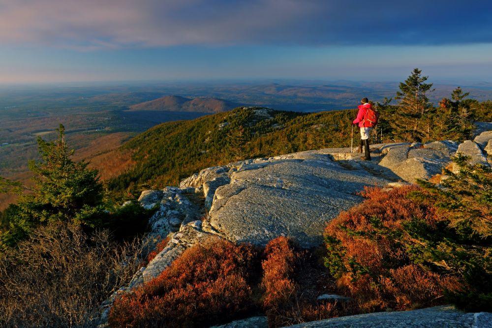 A hiker at the summit of Monadnock.