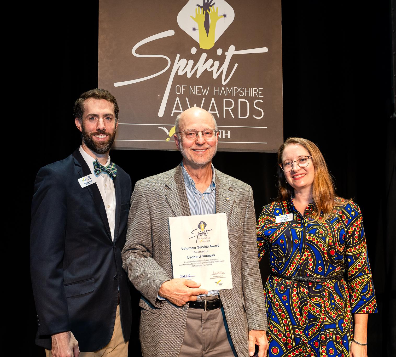 Lee poses with a plaque at the Spirit of NH Awards.