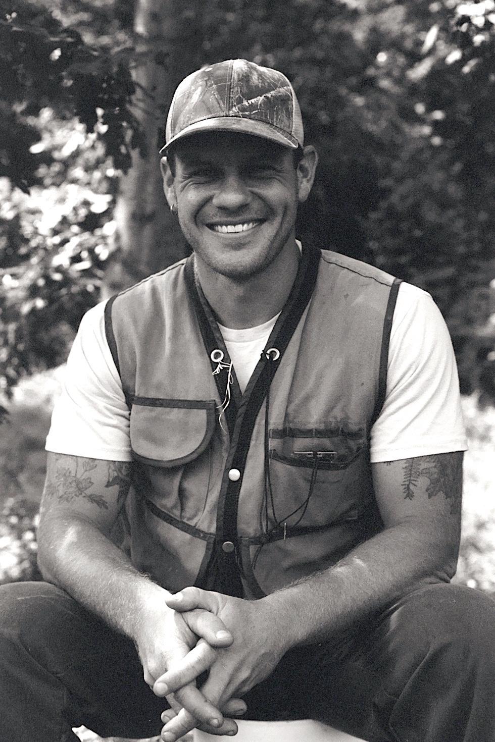 Ethan Tapper sits in the forest.