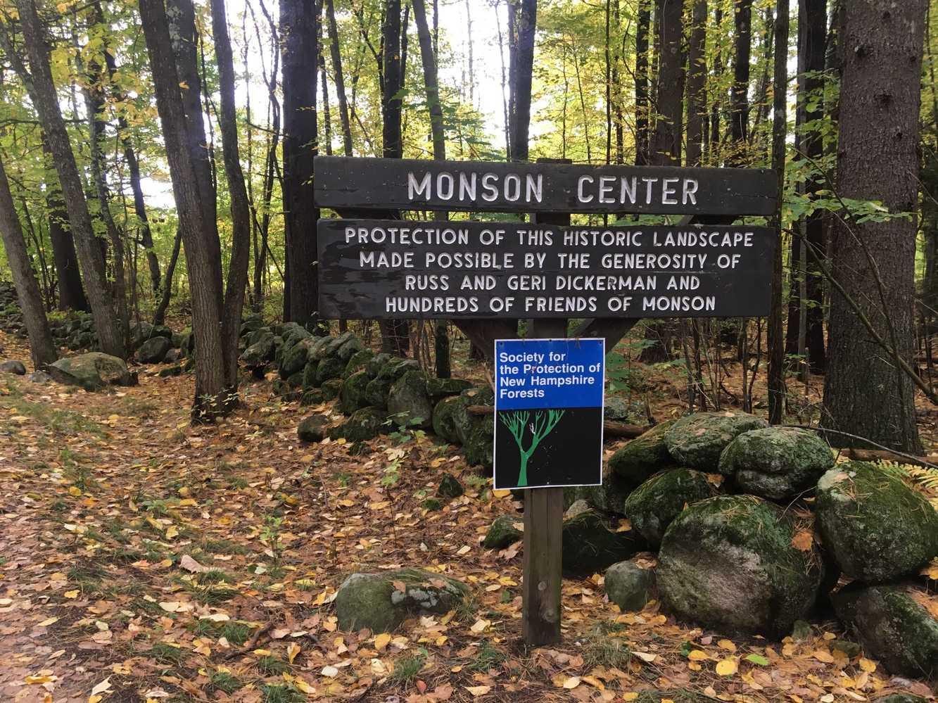 A wood sign at the entrance to Monson Center.