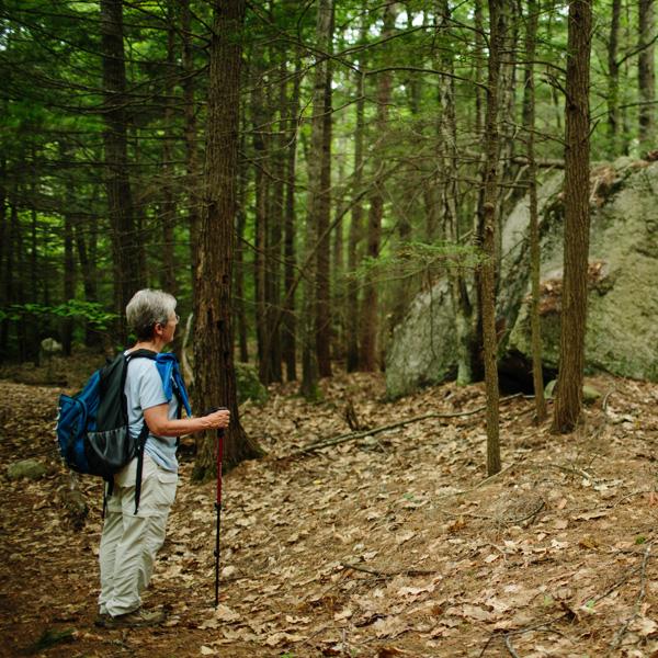 Hiker takes in the view of large boulders on the trail