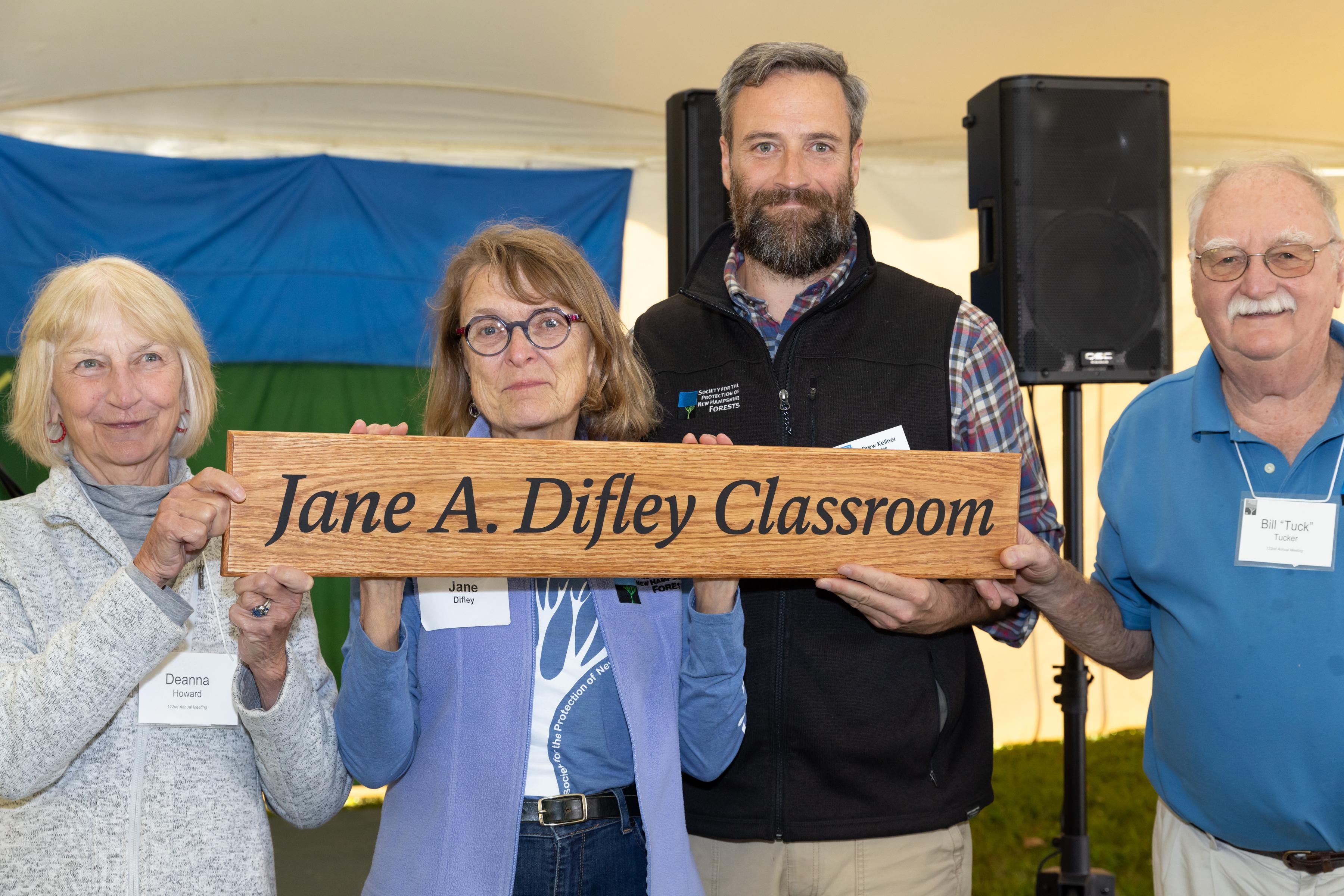 Board chairs past and present and Jack and Jane pose with the sign.