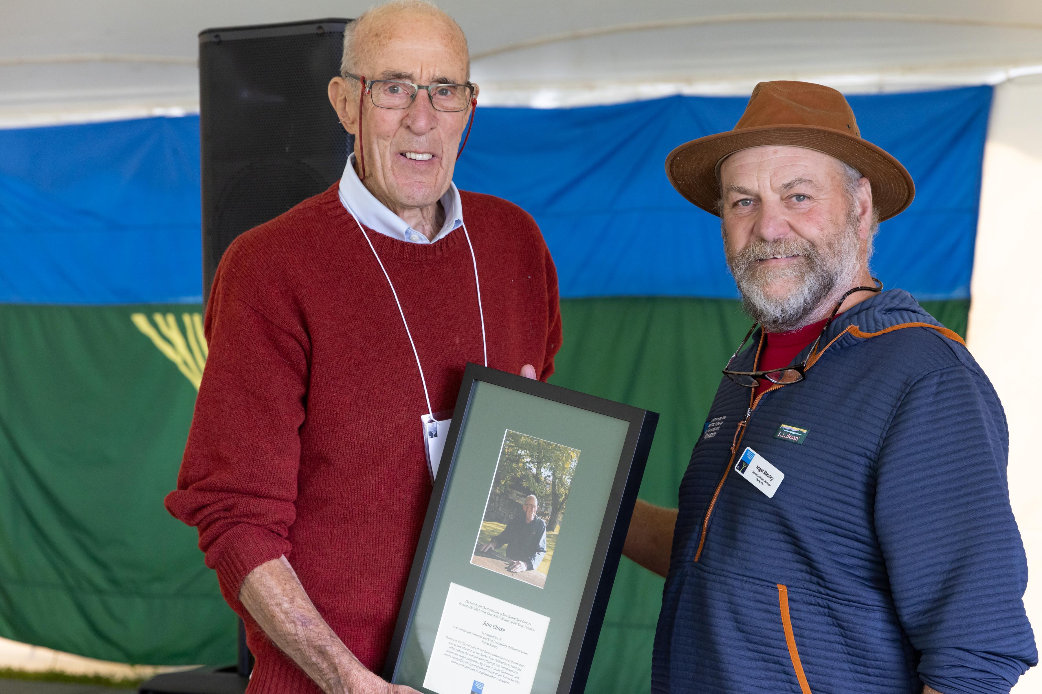 Sam Chase (left) and Nigel Manley pose together with the award.
