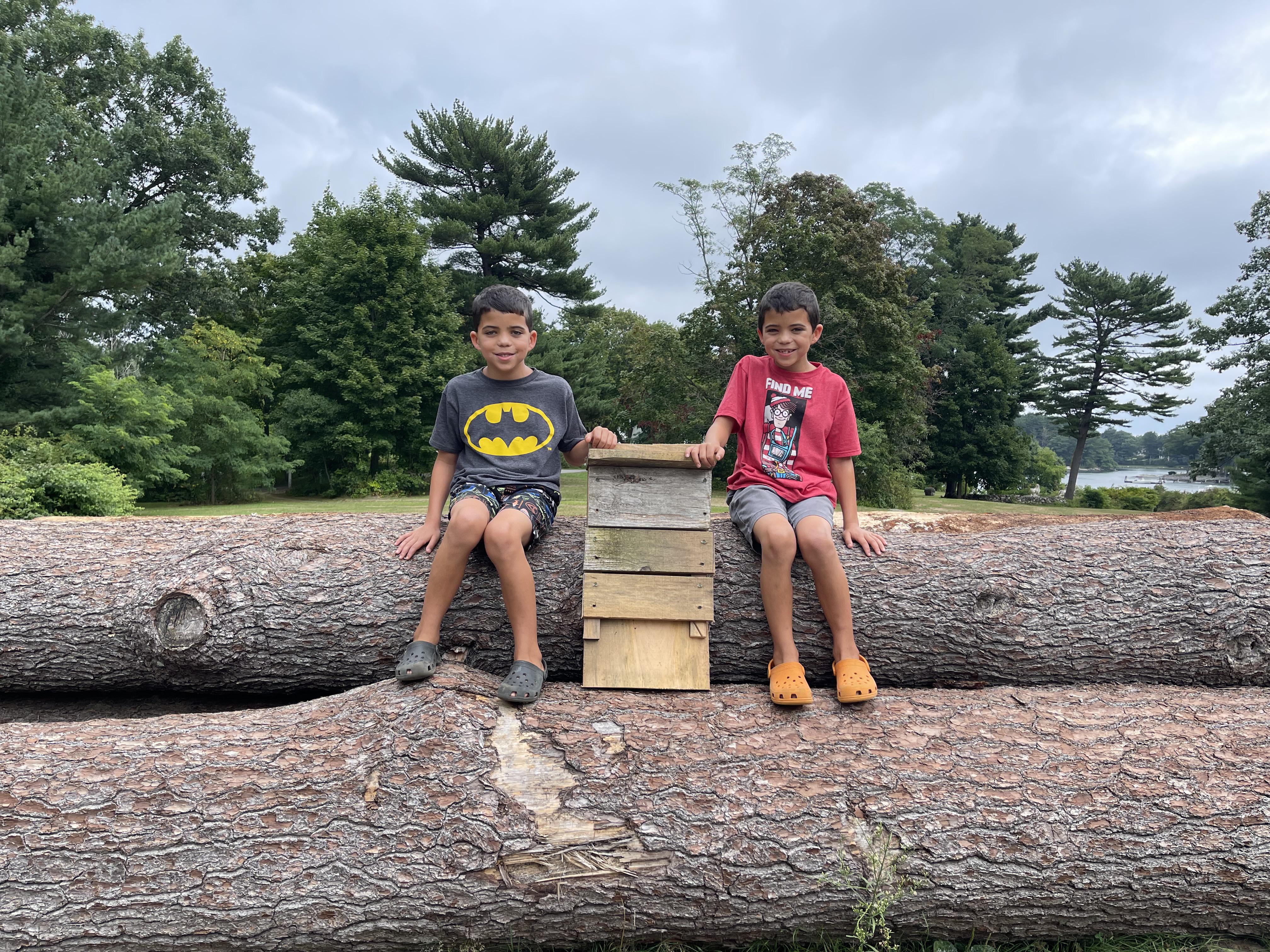 Two children pose with a bat box they made last summer out of the wood.