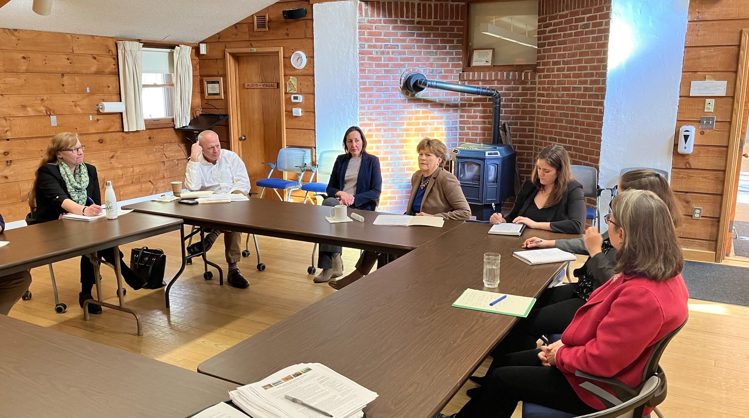 Senator Shaheen and leaders of local conservation groups are gathered at a table in the conference room.