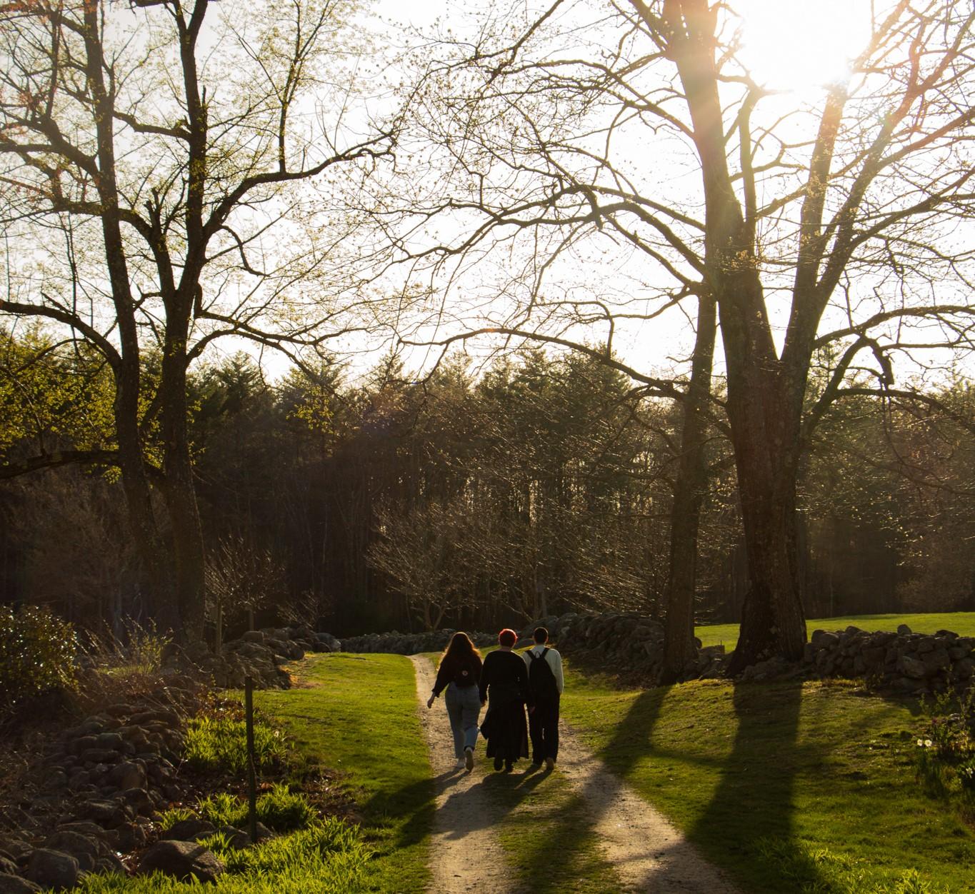 Three young people walk together at Monson Center reservation.