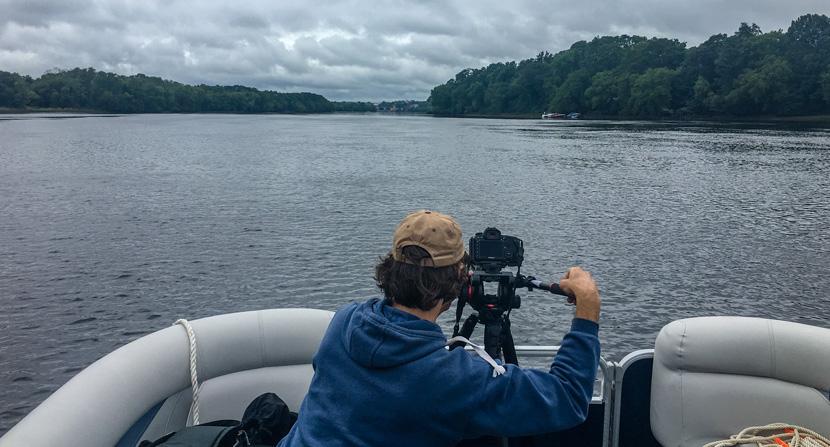Videographer filming lower Merrimack between Newburyport and Haverhill, Mass